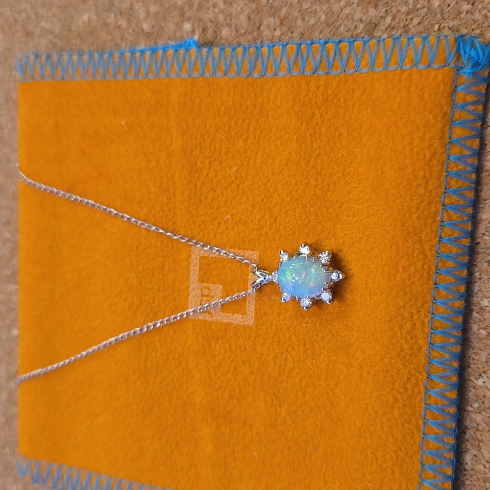 14KT white gold necklace with an oval opal and 8 diamonds